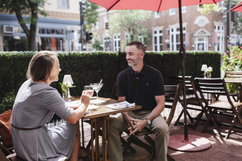 A couple is dining outside in downtown