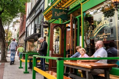 family sitting in outdoor seating at a downtown restaurant.